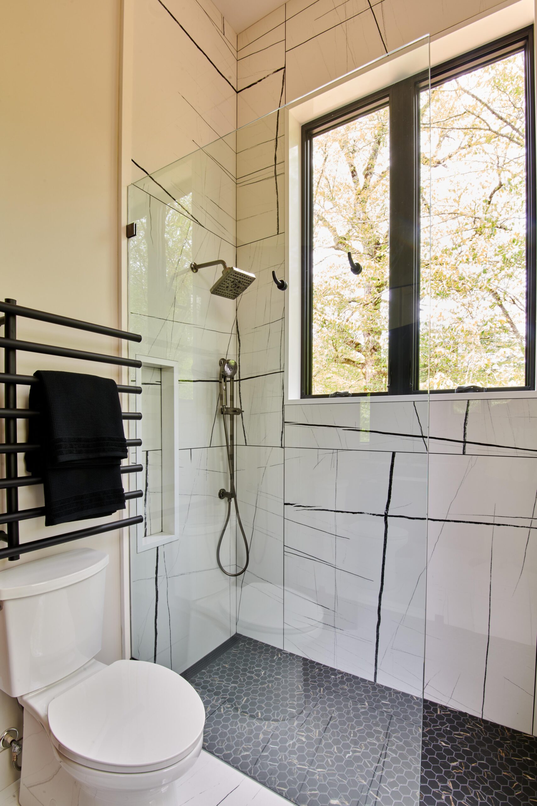 a_bathroom_with_a_toilet_shower_and_window_brdb_highlands_nc_guest_bath_2nd_master_bathroom_