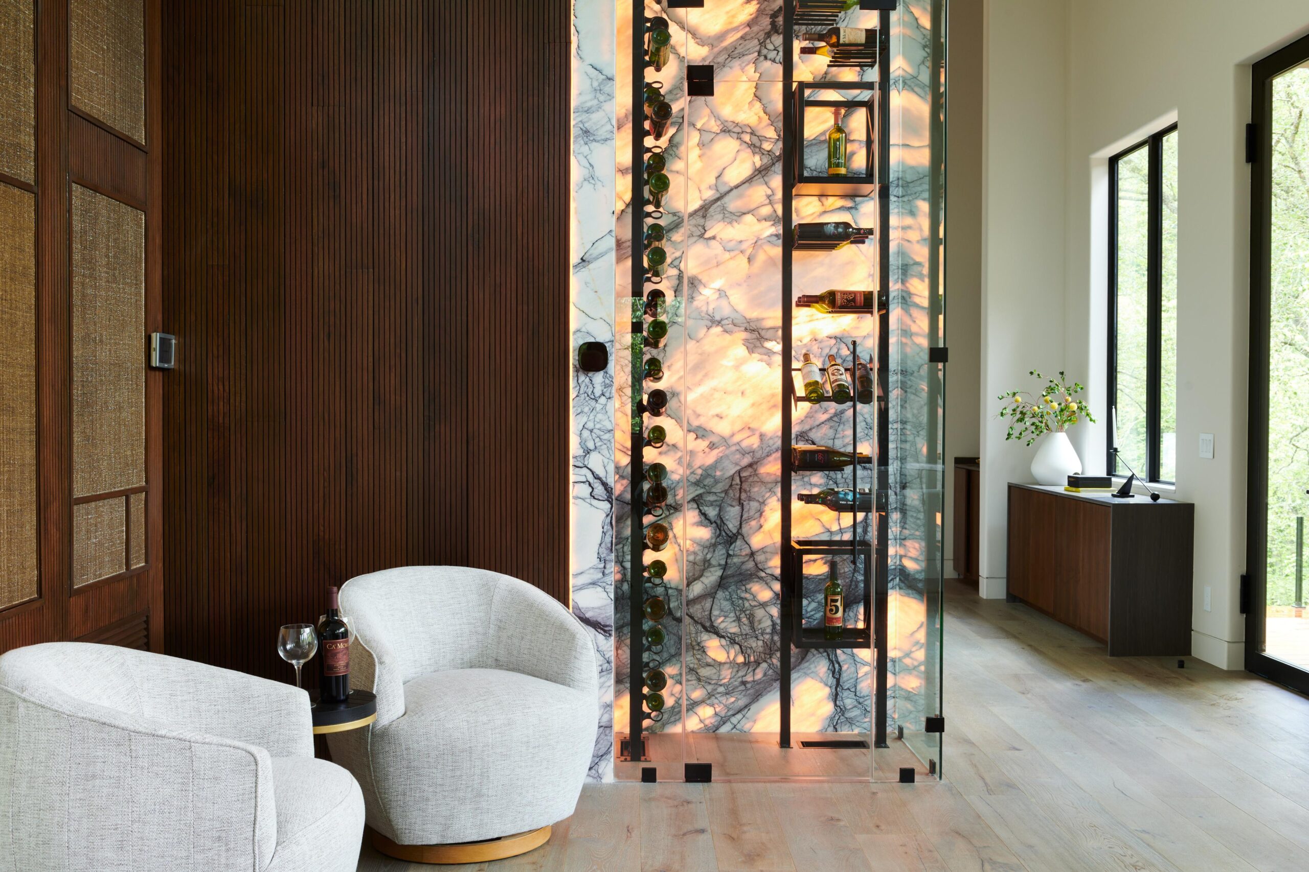 a room with a chair and a wall with a painting brdb highlands bedroom wine room 1 scaled