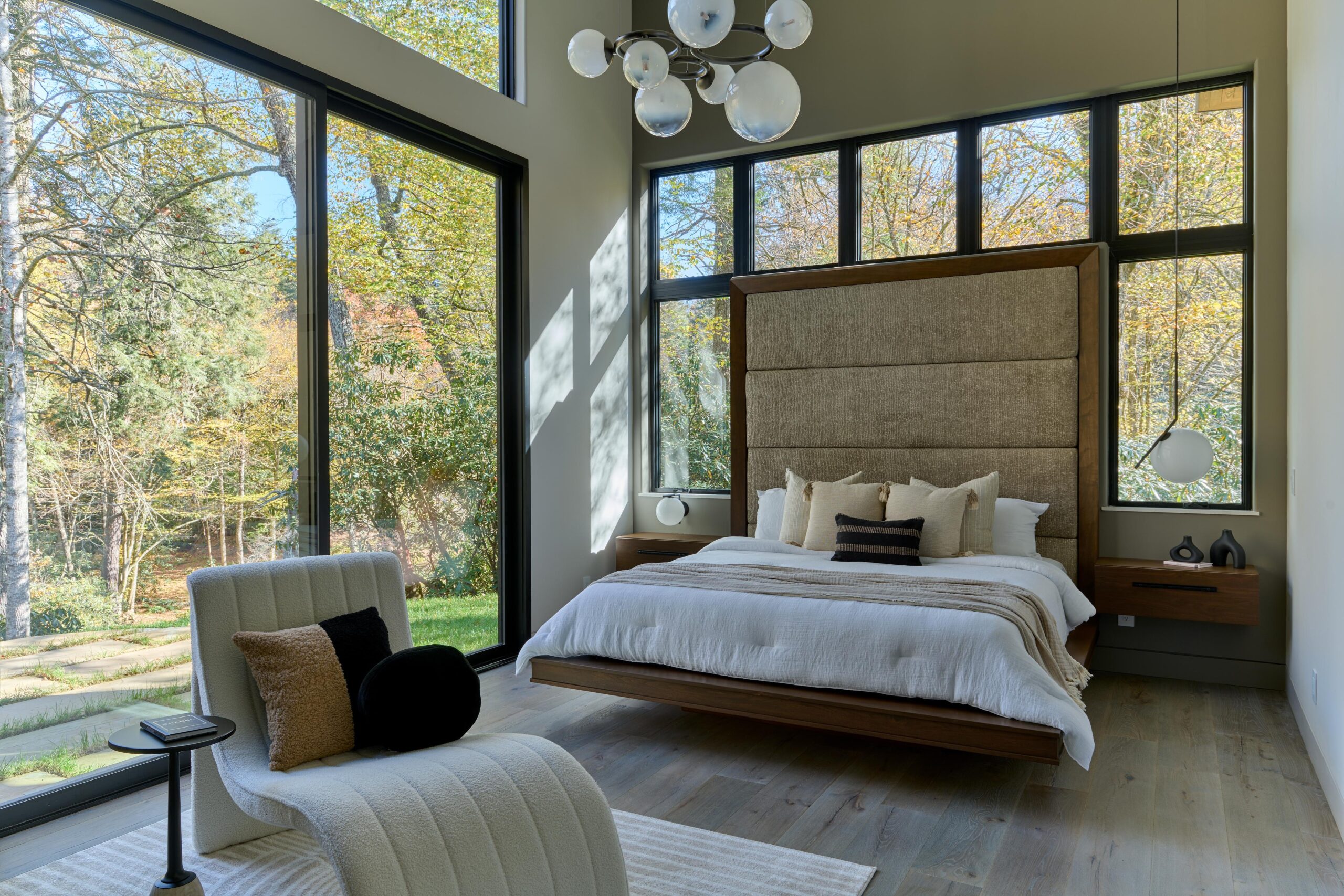 a bedroom with a large bed and a large window highlands nc real estate for sale scaled