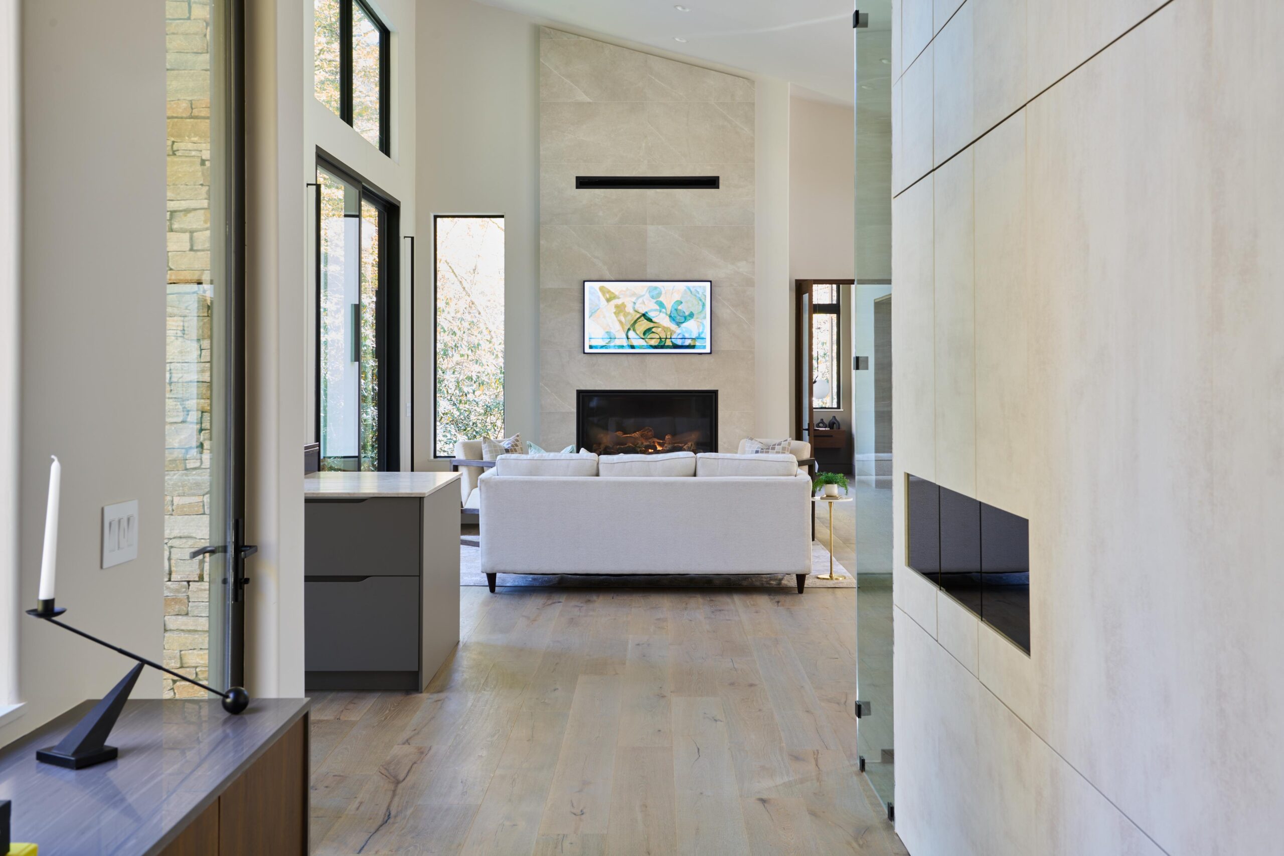 a_long_hallway_with_a_large_window_and_a_tv_brdb_highlands_nc_hallway_