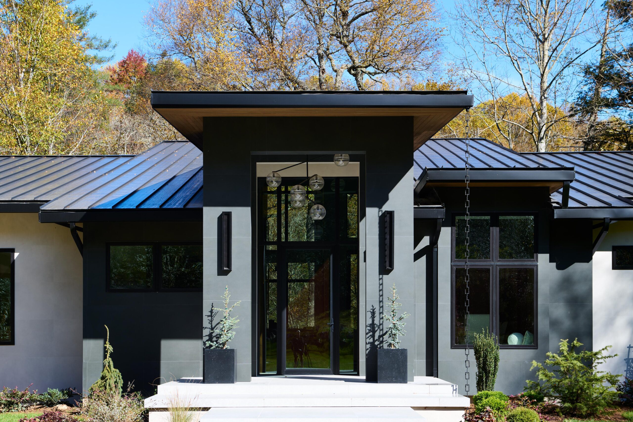 a_house_with_a_patio_and_a_large_tree_brdb_highlands_nc_porch_natural_light