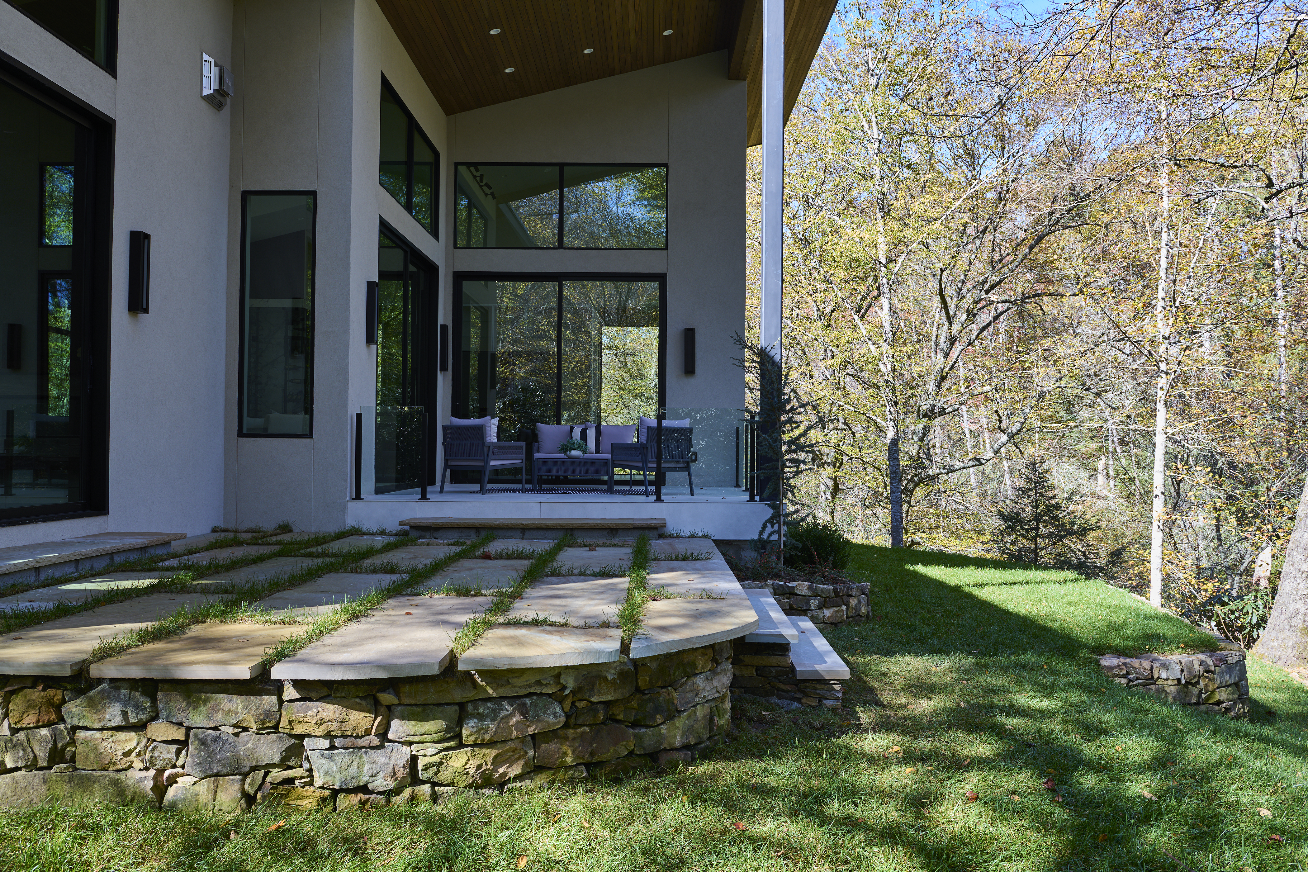 a_modern_house_with_a_wood_roof_and_metal_railing_brdb_highlands_nc_exterior-details_natural_light